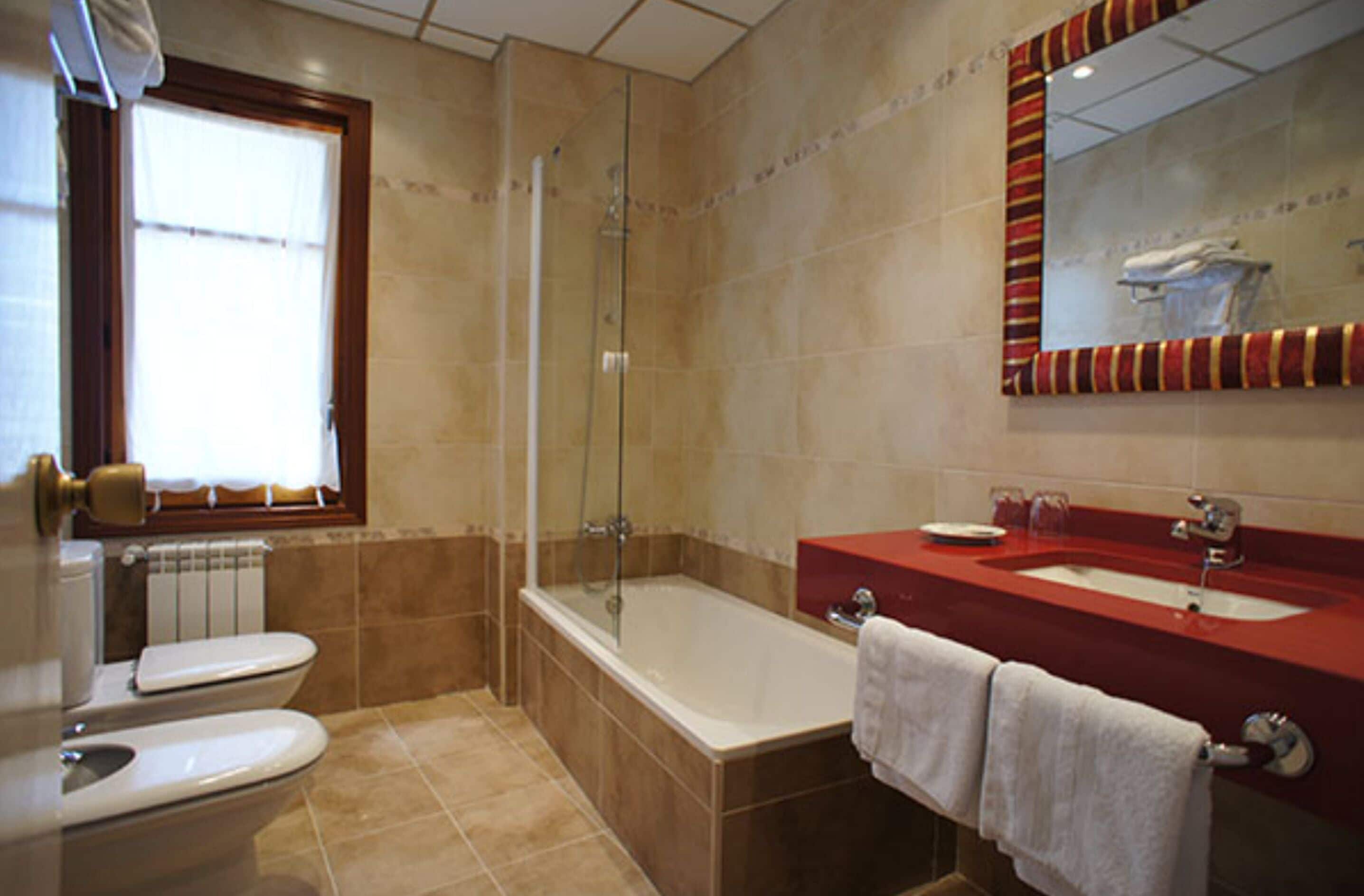 deep-soaking bathtub, hair dryer, bidet, towels