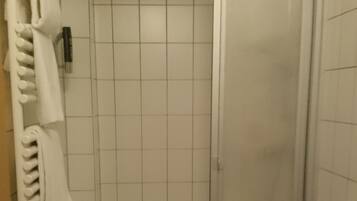 A bathroom with a shower, toilet, and sink.