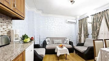 Duplex, 1 Bedroom, Ground Floor (Apartment) | Living area | 82-inch TV with satellite channels, DVD player