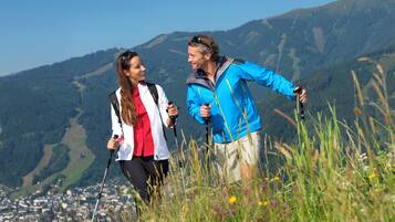 Two people hiking with a mountainous landscape in the background.