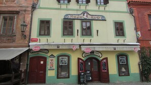 A building with a sign reading "Pension Marie" and a "PIZZA CAFE" sign below. - Pension Marie (Cesky Krumlov)