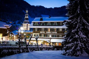 A hotel named "Hotel Christiana" with a prominent tower and snow-covered surroundings. - Christiania (La Clusaz)