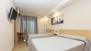 A hotel room with two beds, a TV mounted on the wall, a painting of a cityscape, and a wooden chair. - Hotel Olympia Ronda I (Puig)