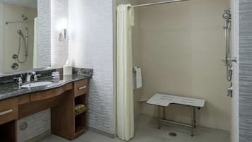 A modern bathroom with a shower, a sink, and a vanity.