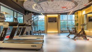 A gym with treadmills, stationary bikes, and weight machines.