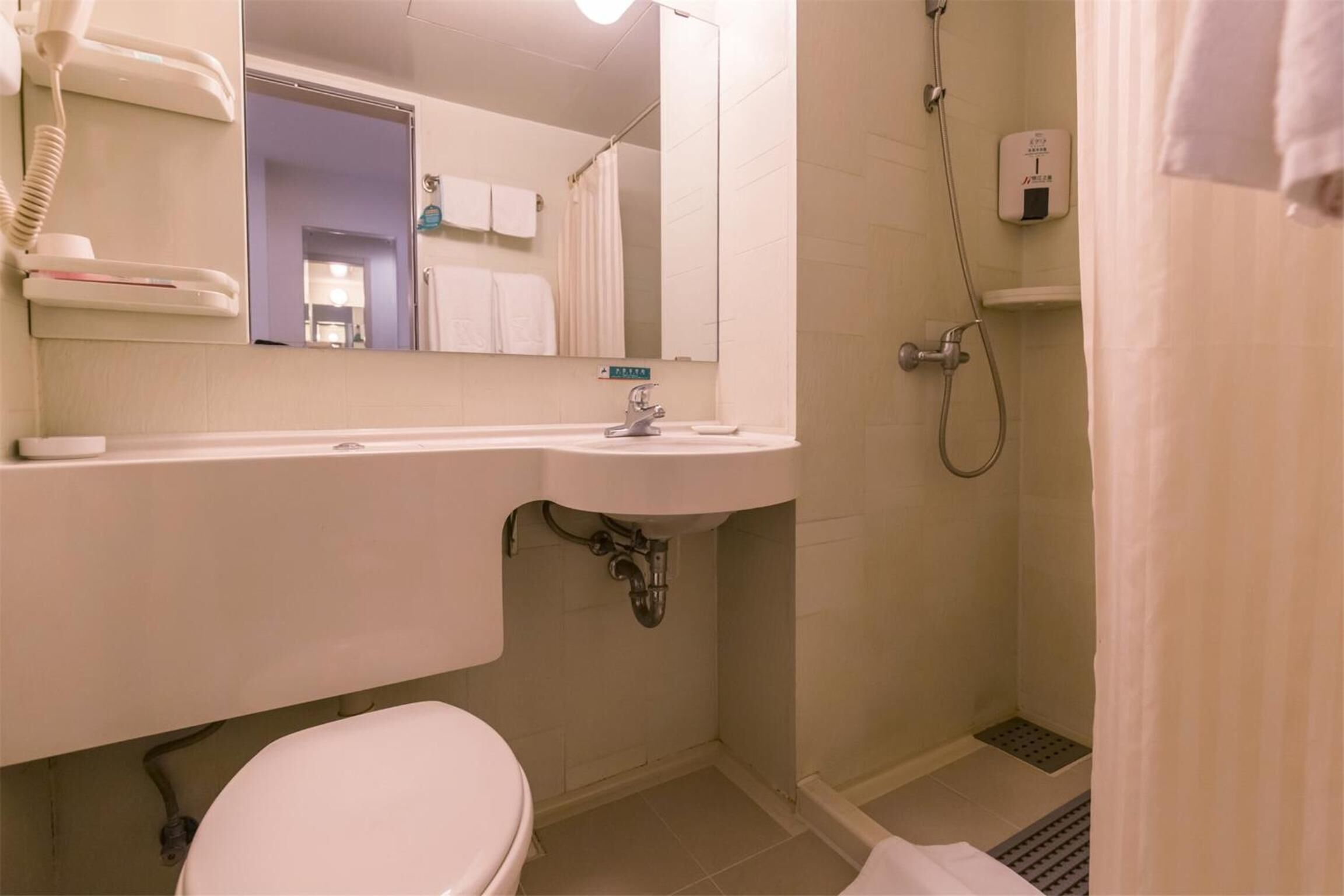 combined shower/bathtub, free toiletries, hair dryer, slippers