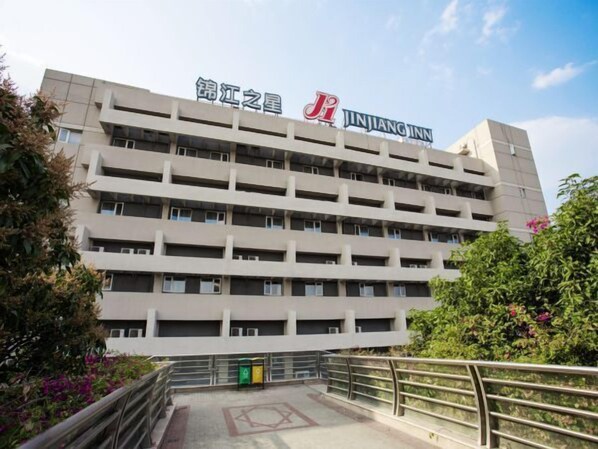 A multi-story building with a sign for Jinjiang Inn.