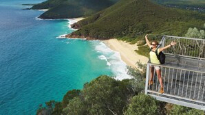 A person standing on a bridge overlooking a beach and ocean. - Hotel Nelson (Nelson Bay)