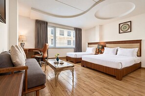 A hotel room with two beds, a sofa, a desk, and a chair. - Sky Gem Hotel - Ben Thanh (Ho Chi Minh City)