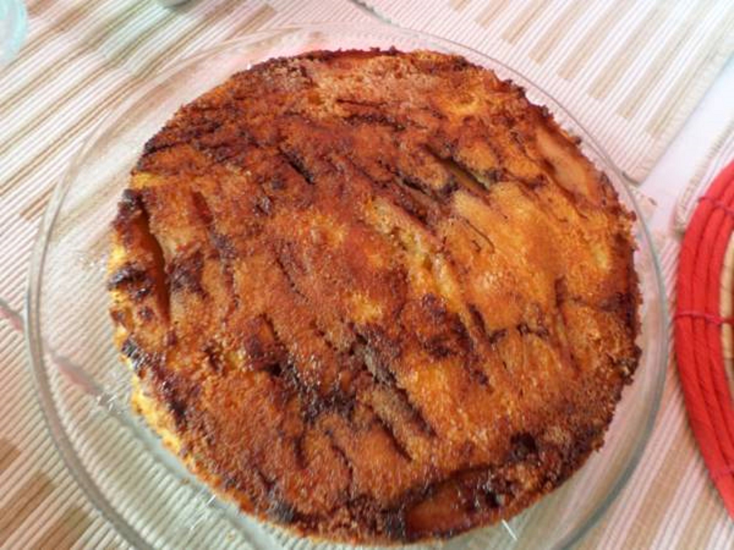Un plato horneado redondo en un recipiente de vidrio transparente.