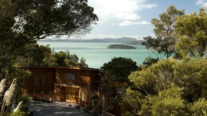 A wooden cabin with a view of a calm lake and distant islands. - The Sanctuary @ Bay of Islands (Opua)