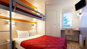 A compact hotel room with a bunk bed, a desk, and a window with a view. - Première Classe Nantes Ouest - Saint Herblain (Saint-Herblain)