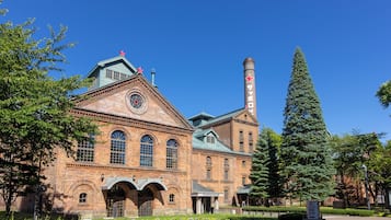 A historic building with arched windows and a prominent chimney.