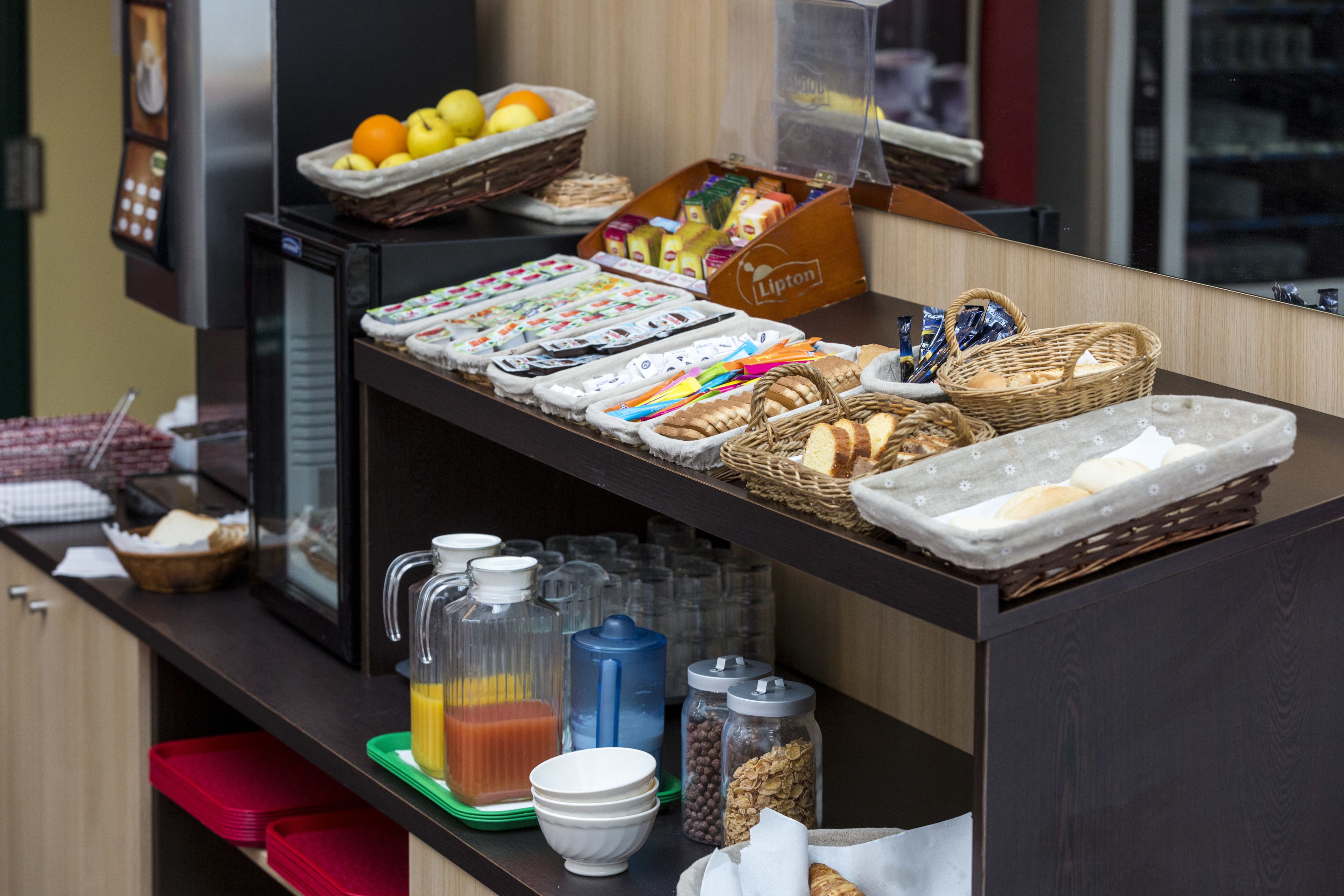 A breakfast buffet with various food items and beverages.