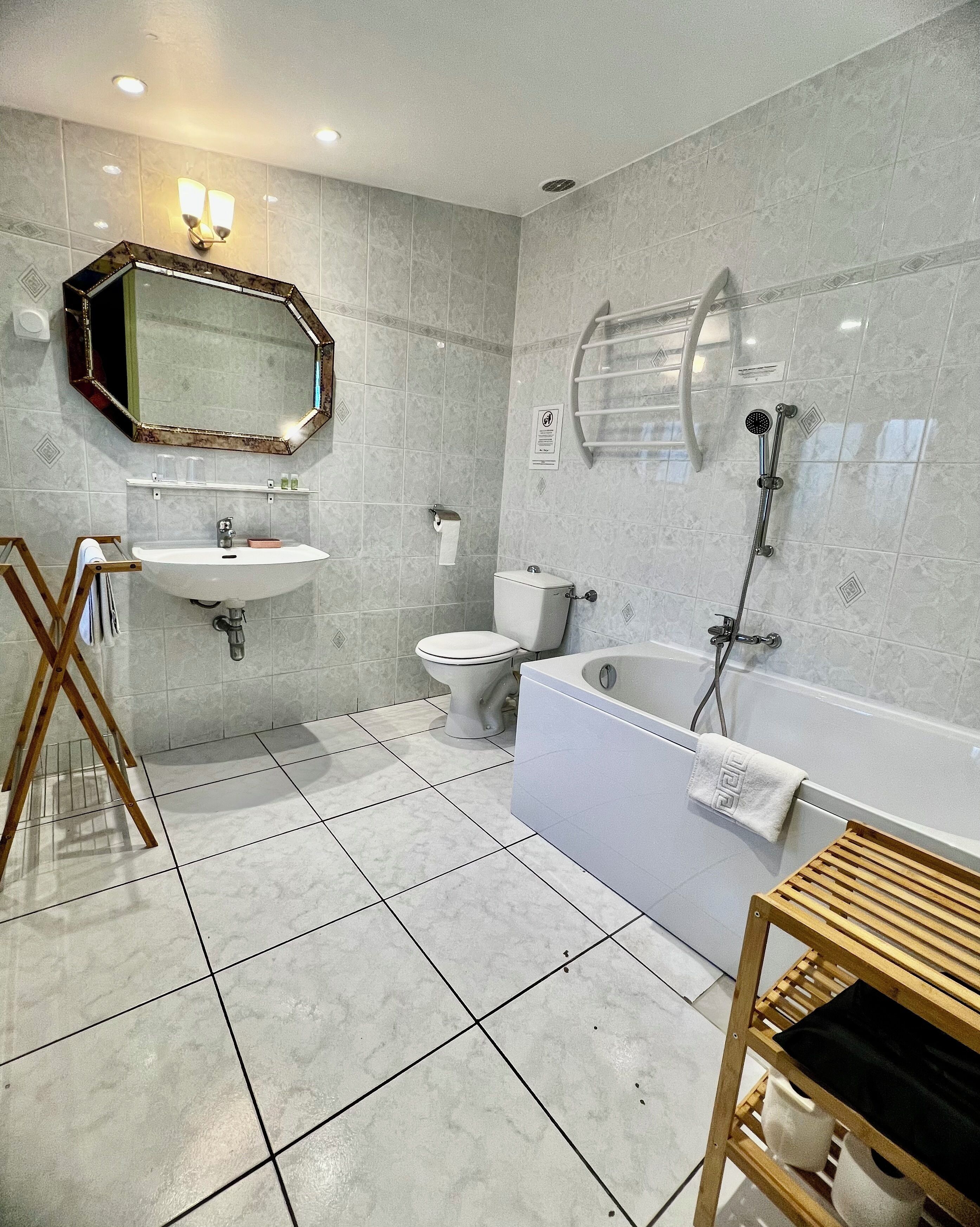 A modern bathroom with a sink, toilet, bathtub, and shower.