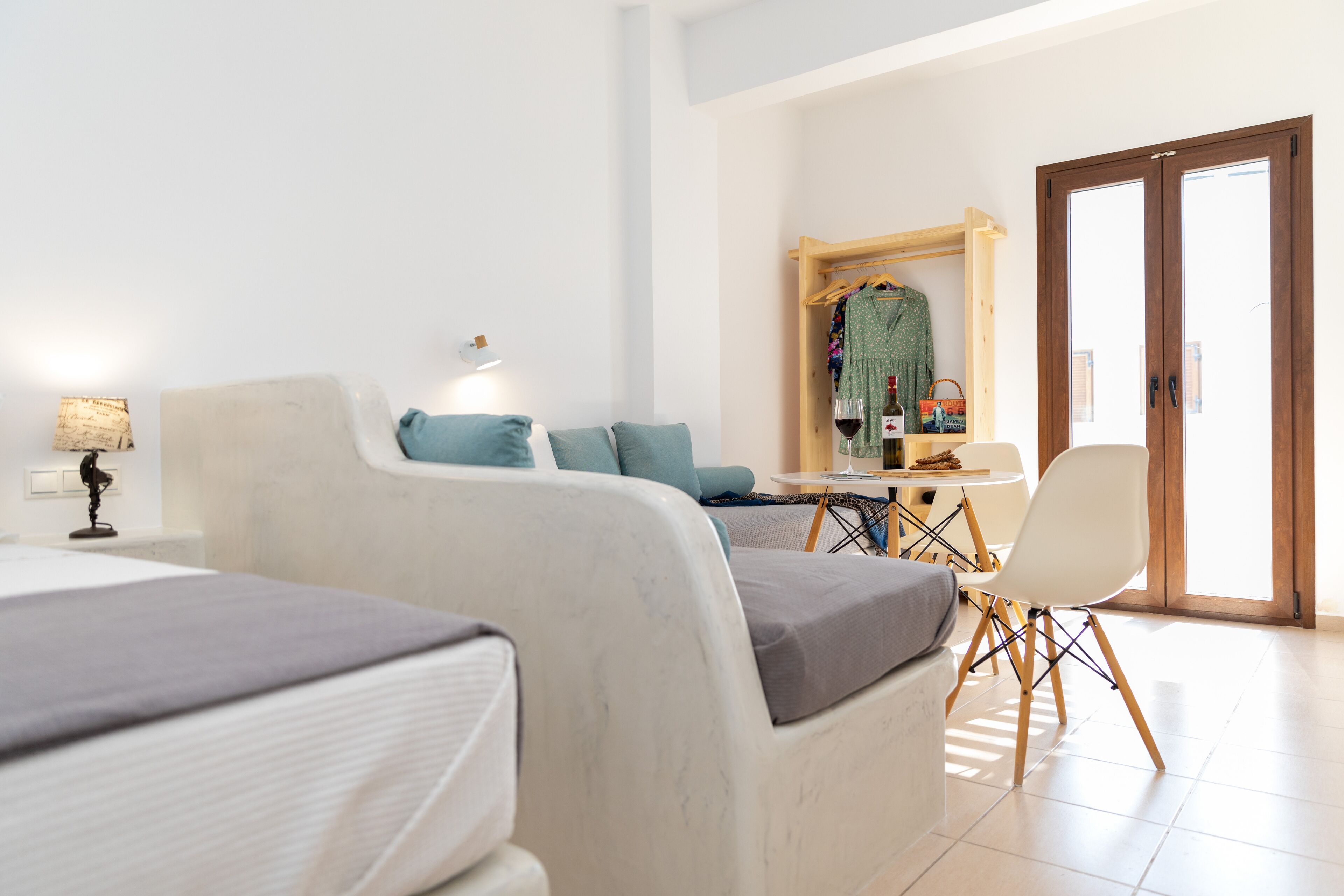 Una habitación de hotel moderna con cama, escritorio, silla y armario.