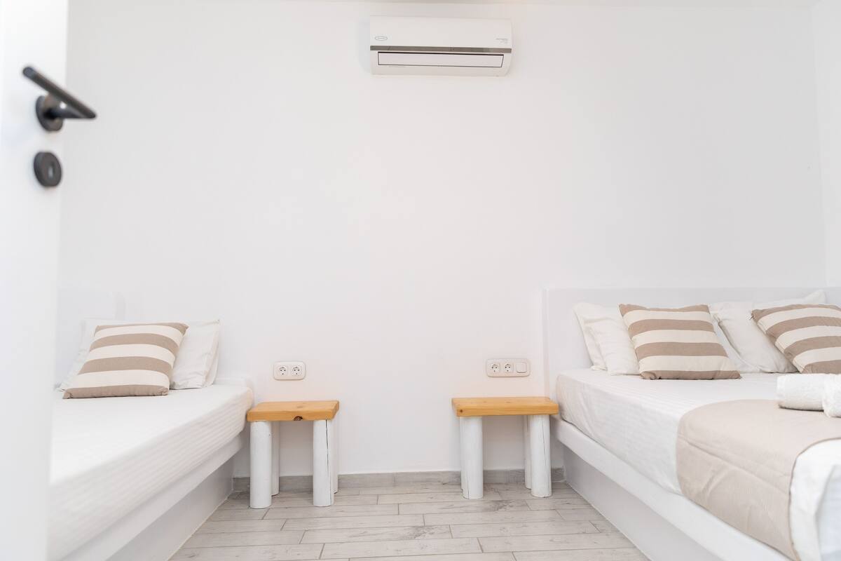Premium bedding, desk, laptop workspace, blackout drapes