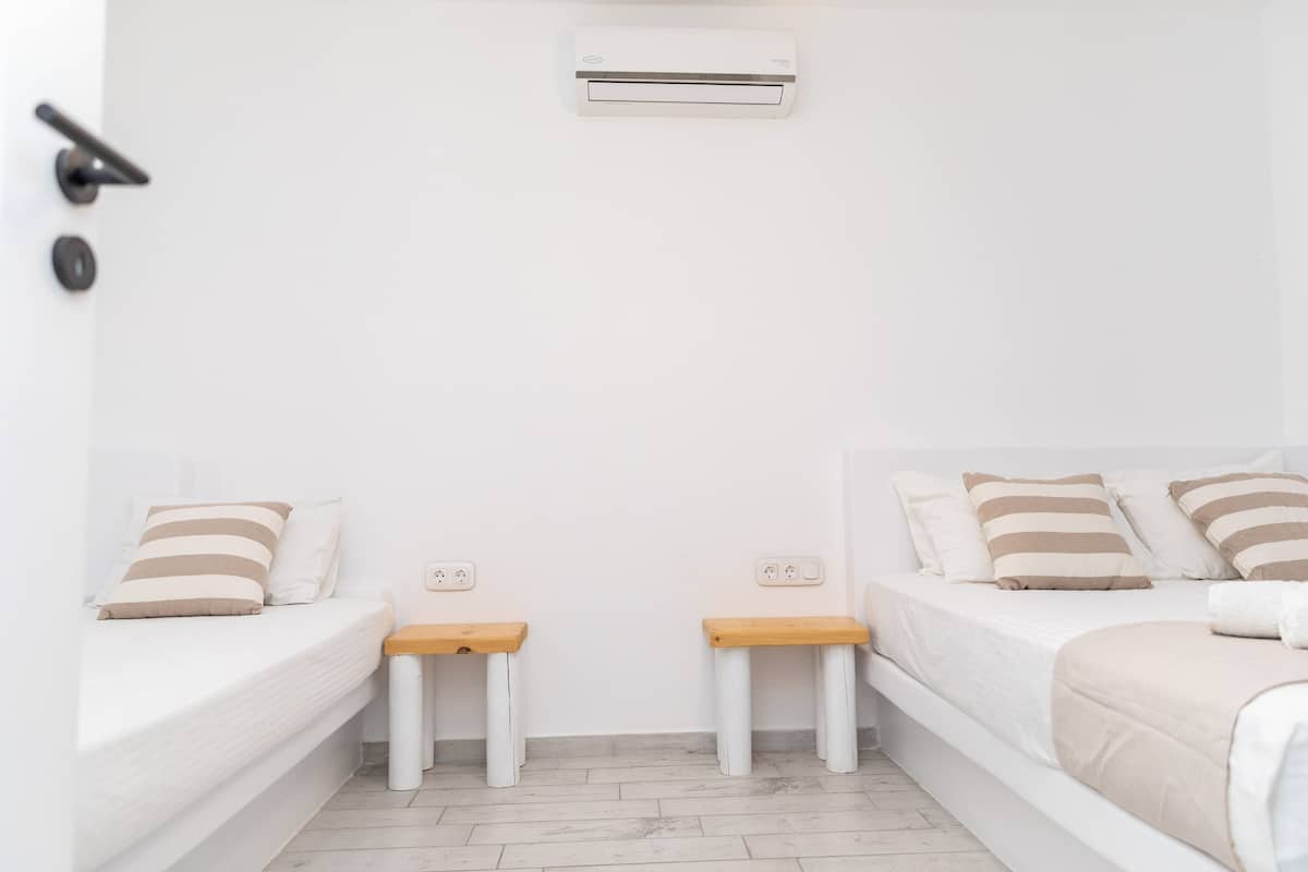 Premium bedding, desk, laptop workspace, blackout drapes