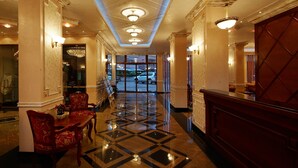 A hotel lobby with a check-in counter, seating area, and a view of the parking lot. - Hotel Karolina (Sunny Beach)