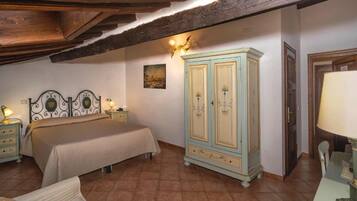 A bedroom with a bed, bedside tables, a wardrobe, and a lamp.
