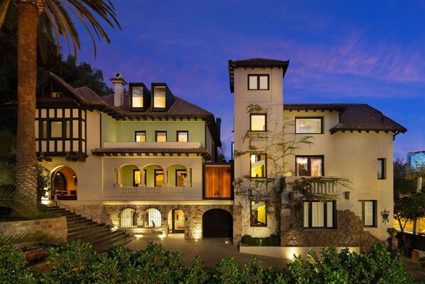 A multi-story building with a stone facade, multiple balconies, and a central tower. - Aubrey Hotel Boutique (Santiago)