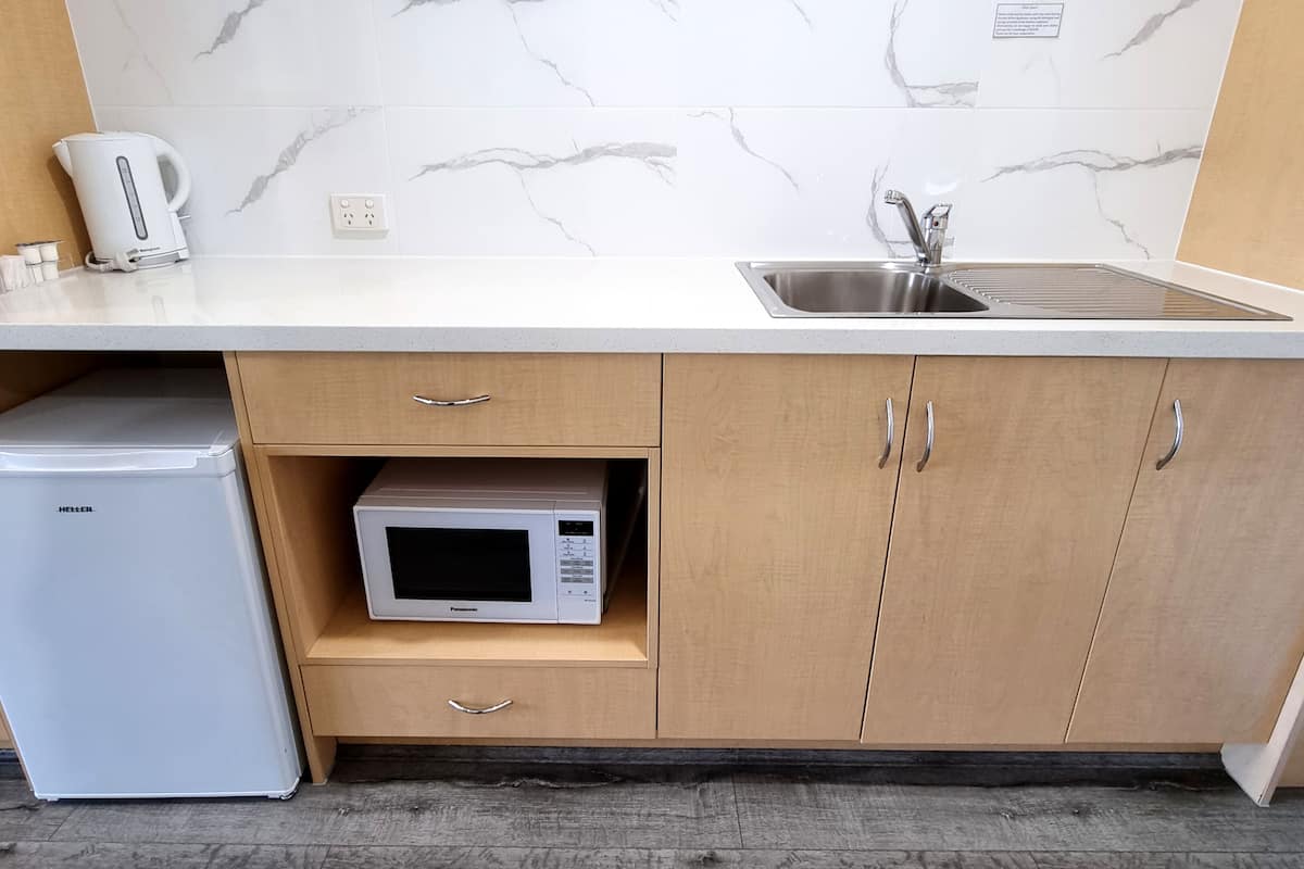 microwave, electric kettle, toaster, cleaning supplies