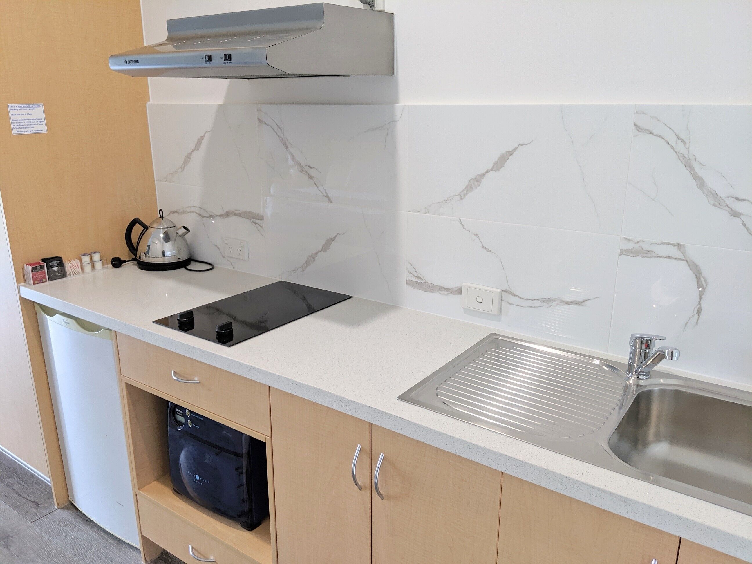 microwave, electric kettle, toaster, cleaning supplies