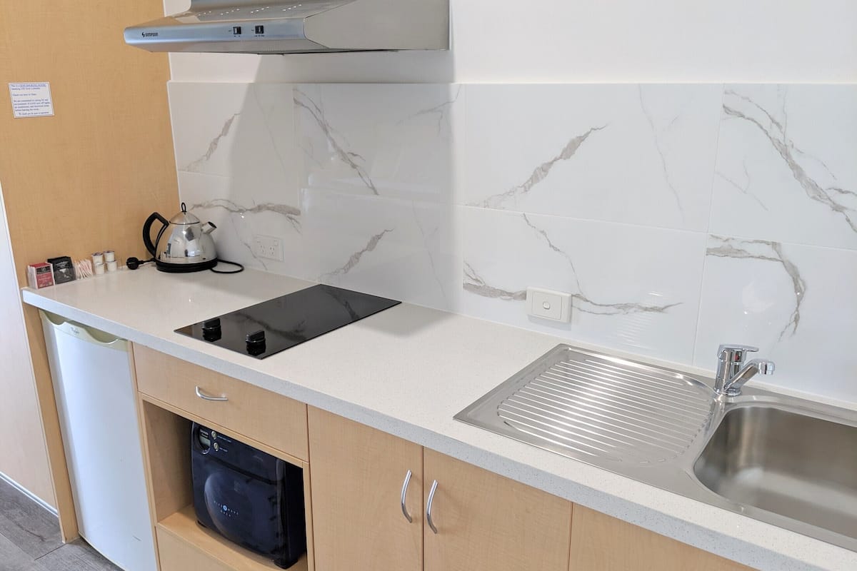 microwave, electric kettle, toaster, cleaning supplies