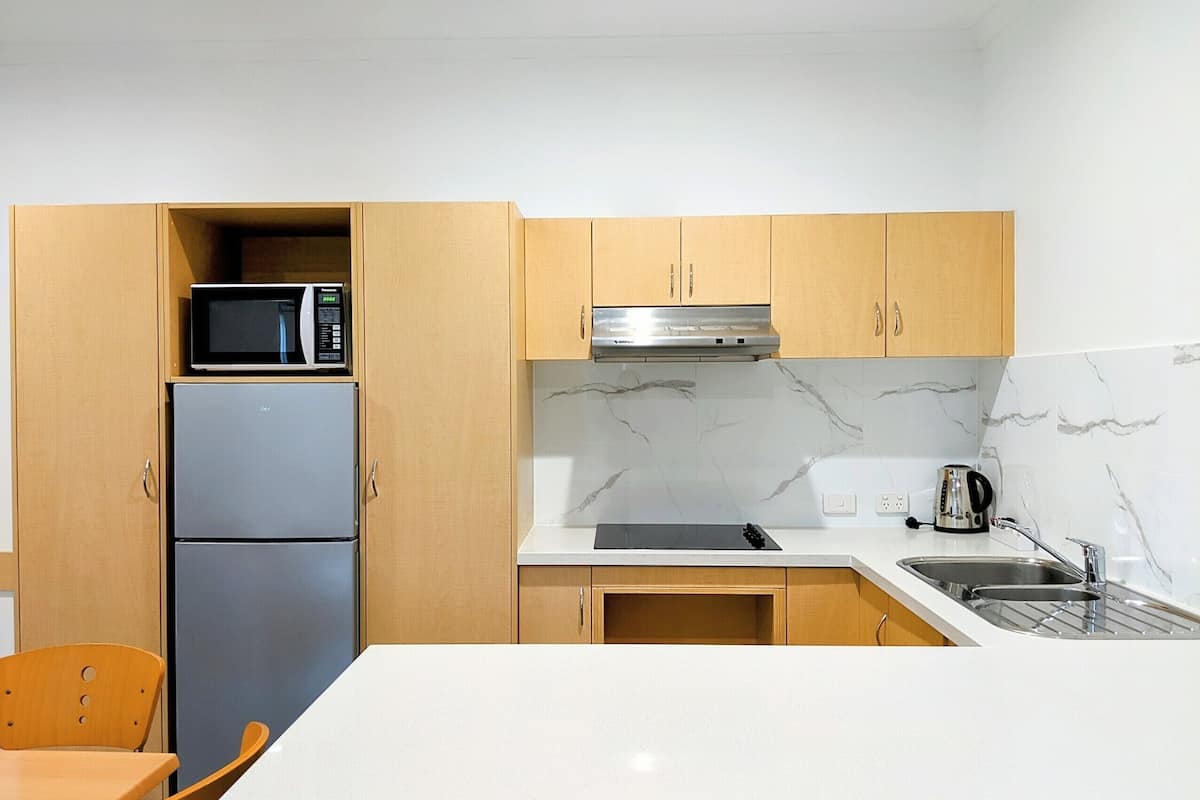 microwave, electric kettle, toaster, cleaning supplies