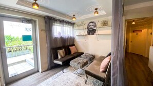 A modern living room with a sofa, a rug, and a wall with artwork.