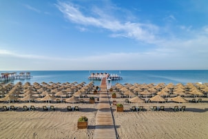 Privat strand, solstolar, parasoller och strandhanddukar