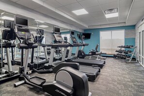A gym with treadmills, ellipticals, and dumbbells. - Fairfield Inn & Suites by Marriott Commerce (Commerce)