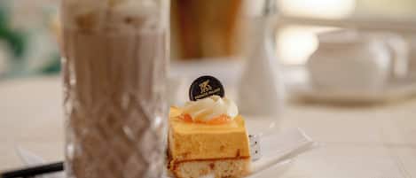 Sobremesa com camada de chocolate e cobertura de creme, servida num prato branco.