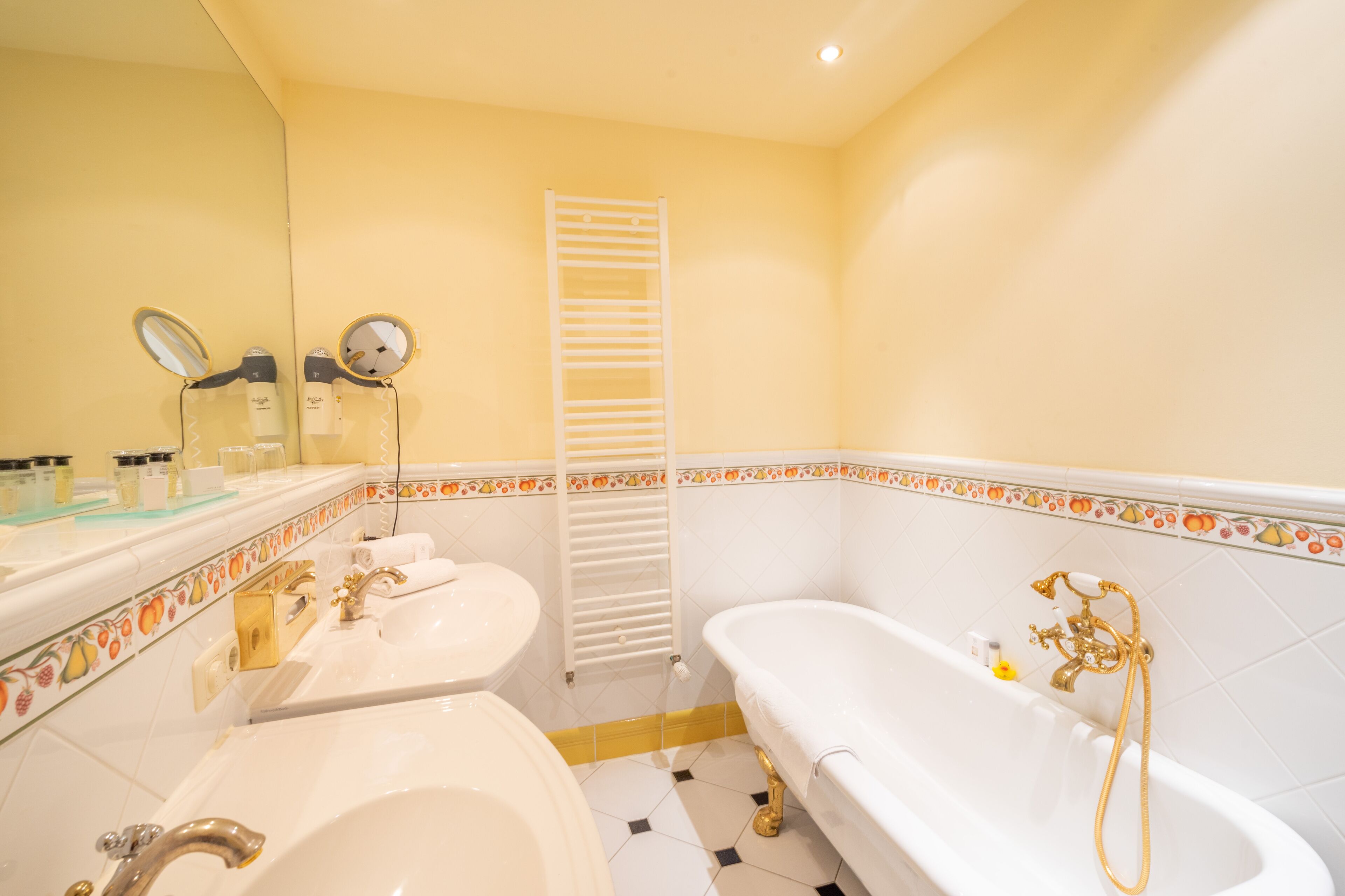 A bathroom with a bathtub, a sink, and a mirror.