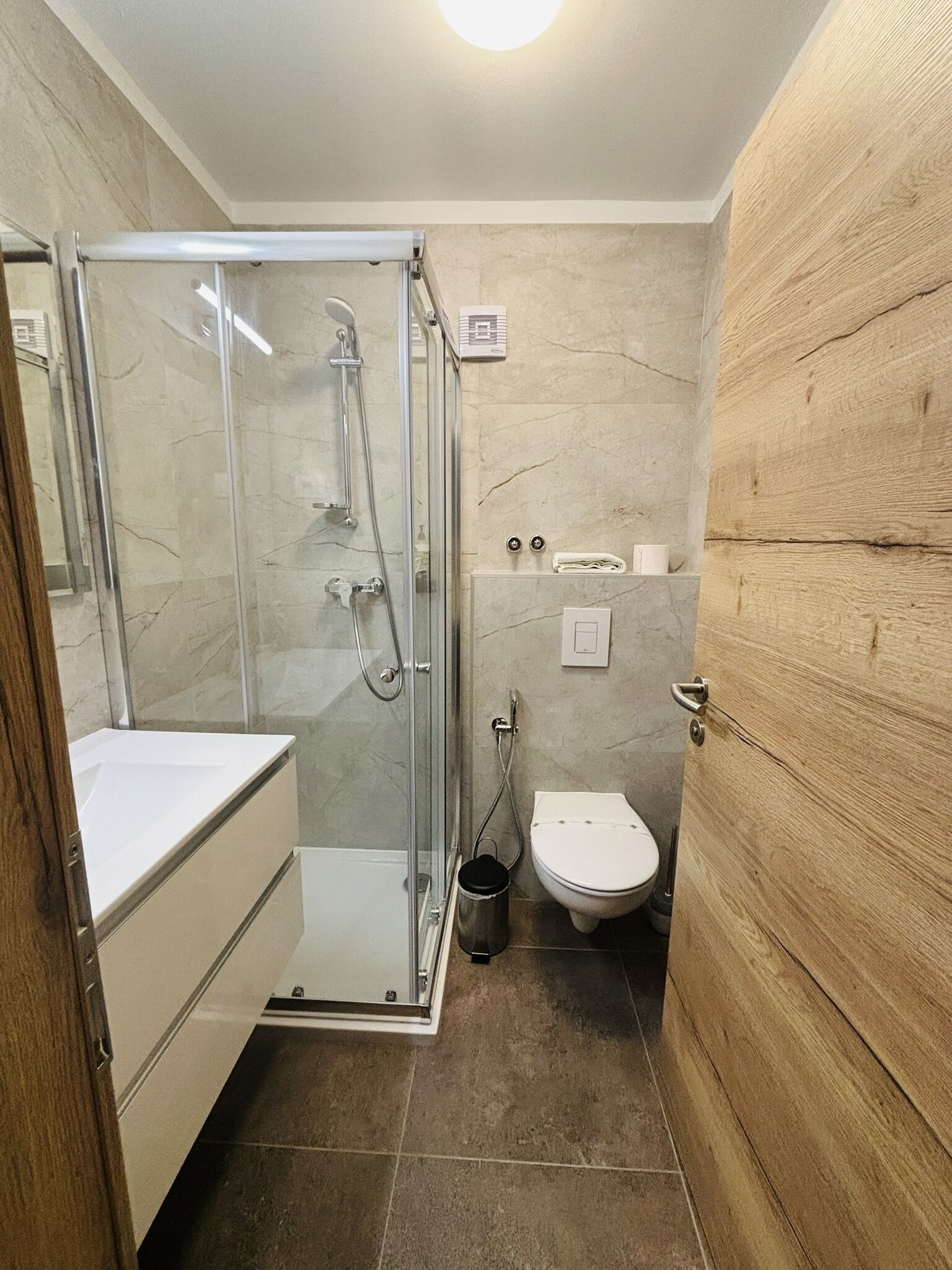 shower, hair dryer, slippers, towels