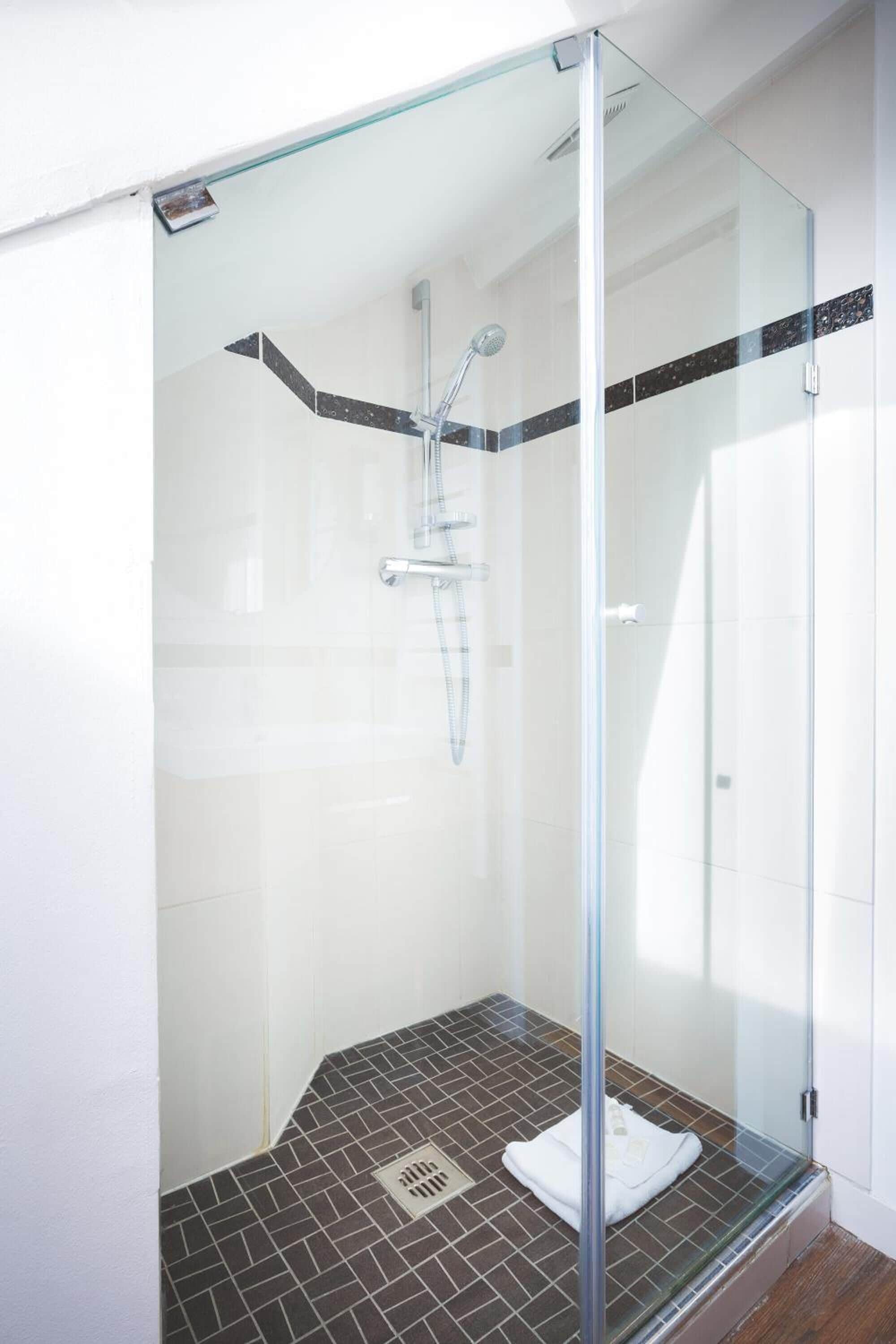 standard double or twin room | bathroom | shower, hair dryer, towels, shampoo