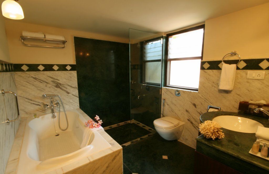 A bathroom with a bathtub, toilet, and sink.