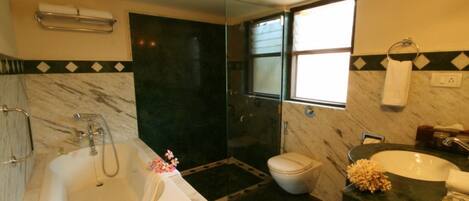 A bathroom with a bathtub, toilet, and sink.