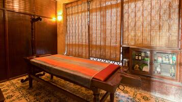 Traditional Japanese-style room with tatami mat floor, low bed, and wooden cabinet.