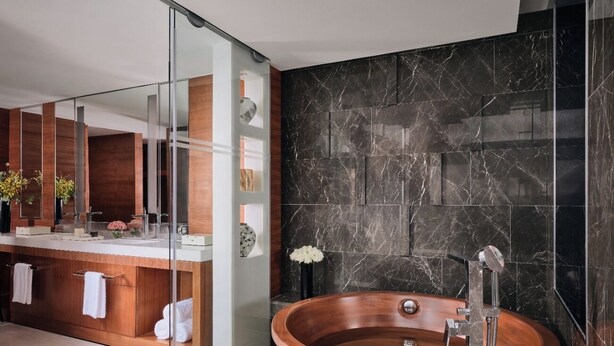 A modern bathroom with a wooden vanity, a large mirror, and a freestanding bathtub. - The Langham, Shanghai, Xintiandi (Shanghai)