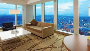 A modern hotel room with a large city view, a sofa, a coffee table, and a desk. - The Westin Sendai (Sendai)