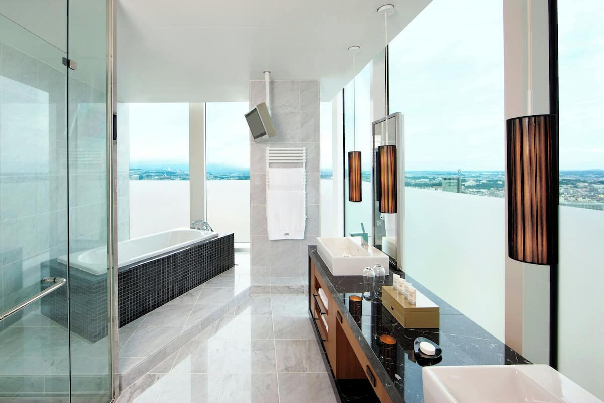 executive suite, 1 king bed, corner | bathroom | separate bathtub and shower, free toiletries, hair dryer, bathrobes