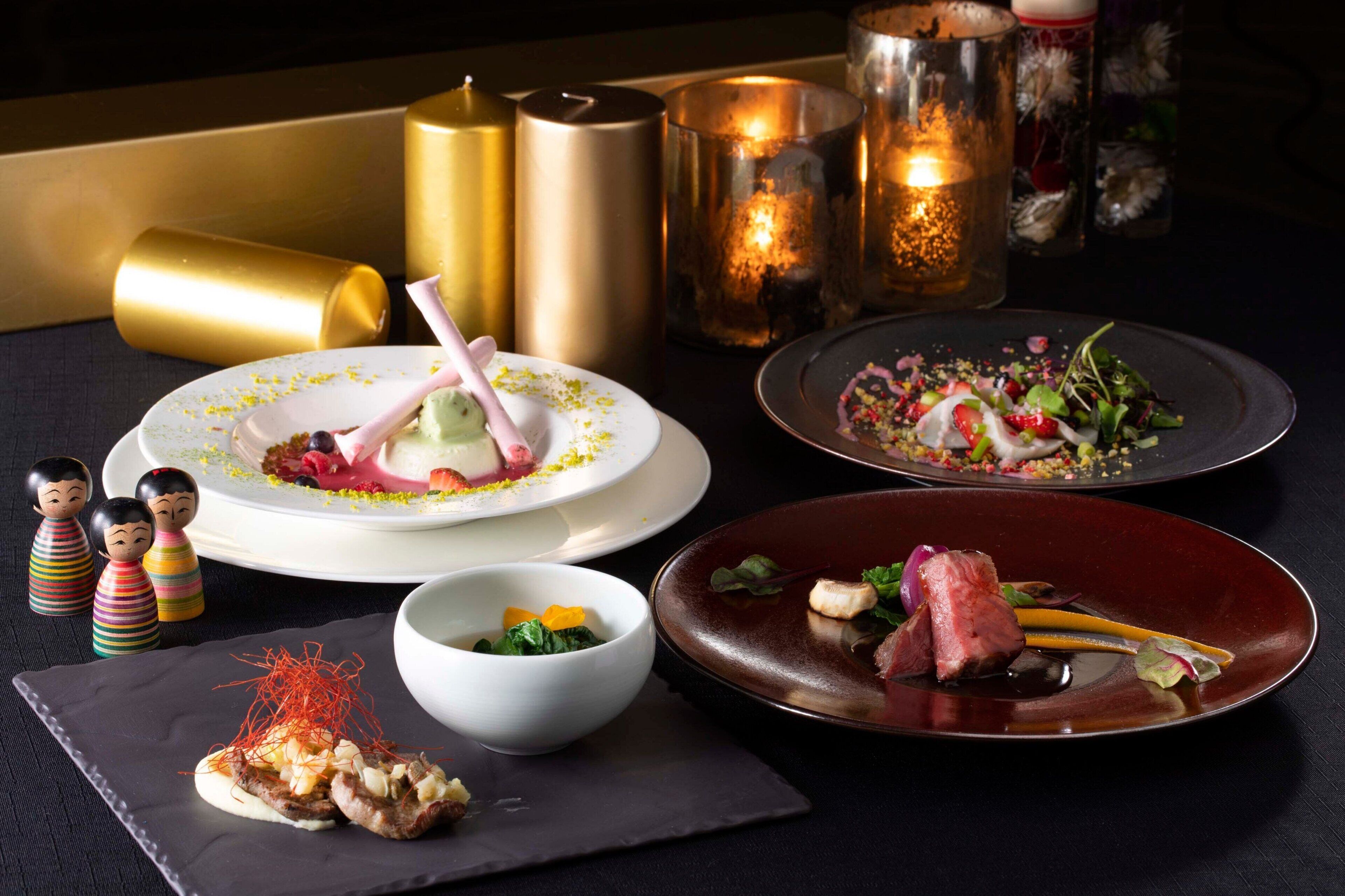 A table with various dishes, candles, and decorative items.