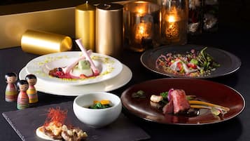 A table with various dishes, candles, and decorative items.
