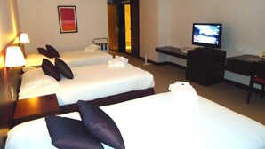 A hotel room with two beds, a TV, a desk, and a red abstract painting on the wall. - Al Jazira Club Hotel (Abu Dhabi)