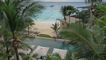 A resort with a pool, beach, and ocean view.
