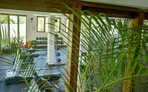 A gym with exercise equipment, a rack of dumbbells, and a treadmill. - Z Hotel & Z2 Hotel (Nungwi)
