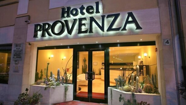 The exterior of Hotel Provence with a modern design, featuring a prominent entrance and a well-lit facade. - Hotel Provenza (Ventimiglia)