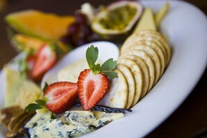 A plate of assorted cheeses and fruits. - Kacys Bargara Beach Motel (Bargara)