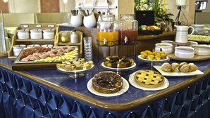 A buffet with various food items, including pastries, fruits, and beverages. - Strand (Bellaria-Igea Marina)